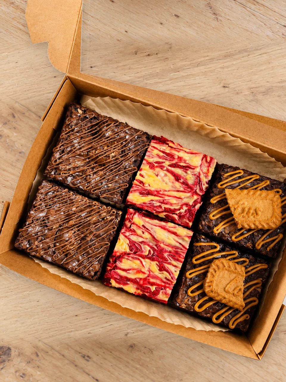 Assorted handcrafted brownies in an open bakery box