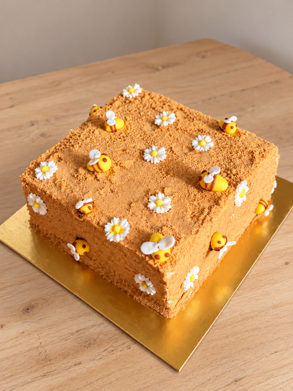 Square custom cake decorated with bees and daisies